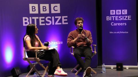 Two people sat talking infront of the BBC Bitesize Careers logo.