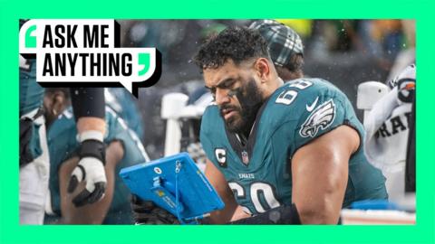 NFL player studying game film