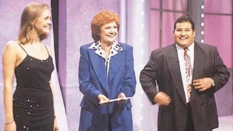 Jenni Falconer, presenter Cilla Black and Donda Michaelas standing on the Blind Date studio set in 1994