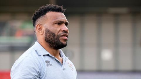 Salford Red Devils' Emmanuel Waine is carried off the pitch