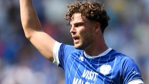 Ollie Tanner raises his right arm