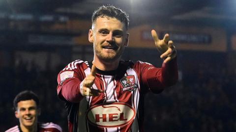 Jack McMillan celebrates scoring for Exeter City