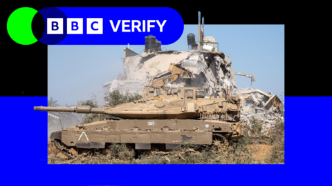 An Israeli tank parked next to the ruins of a building in the Gaza Strip.