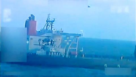 The tanker is seen with a bird flying above it with a military style crosshair overlain in a grab from video
