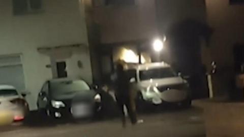 Man shooting at a house.