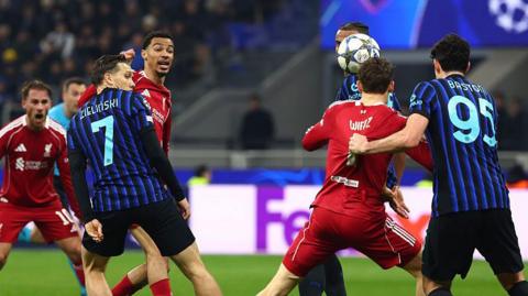 Florian Wirtz, right, has his shirt pulled by Alessandro Bastoni