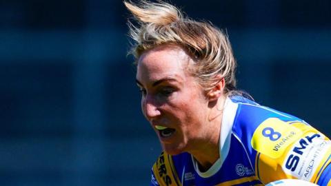 Bethan Dainton, carrying the rugby ball in her left hand, playing for Leeds Rhinos