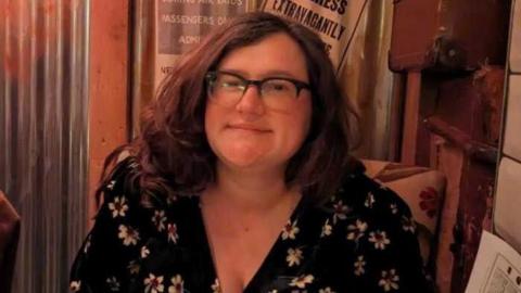 Head and shoulders image of Alice Topping wearing a black top with white flowers