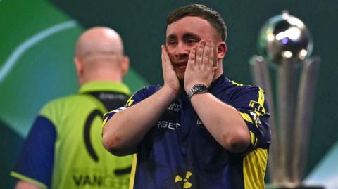 Luke Littler reacts after beating Michael van Gerwen to win the 2025 World Darts Championship