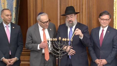 From left, Hakeem Jeffries, Chuck Schumer and Mike Johnson during the Menorah lighting ceremony.
