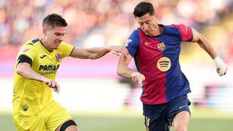 Robert Lewandowski of Barcelona running with the ball