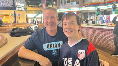 Image shows USA supporters Jim House and his son Maxwell