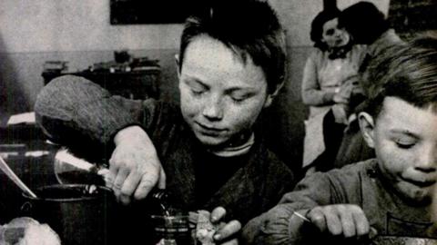 A child pours wine in 1954