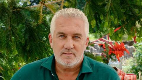 Paul Hollywood in a green shirt set against a green background
