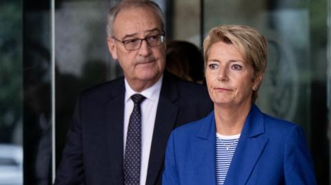 A gloomy looking Karin Keller-Sutter, with economy minister Guy Parmelin, leave the US Department of State after talks in August.