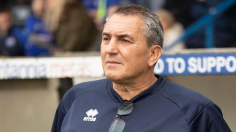 Richard Dryden standing in the dugout
