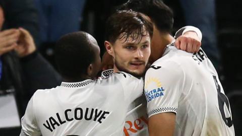 Liam Cullen congratulated by Swansea team-mates