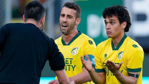 Referee Dennis Higler interacts with Fortuna Sittard's Ivo Pinto and Josip Mitrovic