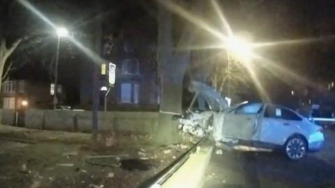 White BMW at night with a smash front end having hit a tree