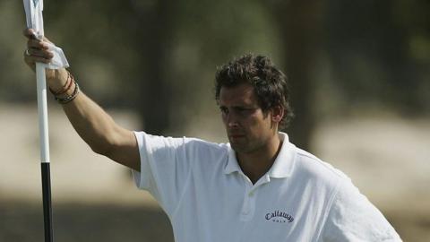 Jamil Qureshi, pictured in 2006, steadies a golf flag with his right hand