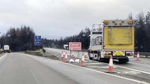 An empty motorway junction with a road closed sign