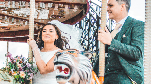 Harmony and Seán smiling on merry-go-round
