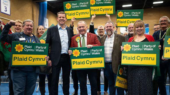 Plaid Cymru candidate Lindsay Whittle (C) and Plaid Cymru leader Rhun ap Iorwerth (L) celebrate winning the Caerphilly seat