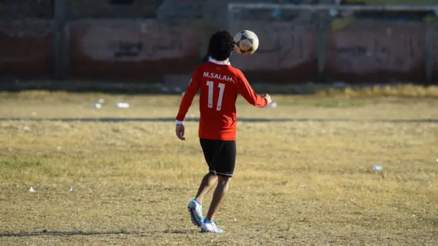 An Egyptian boy plays football at the Mohamed Salah Youth Center in the Egyptian village of Nagrig