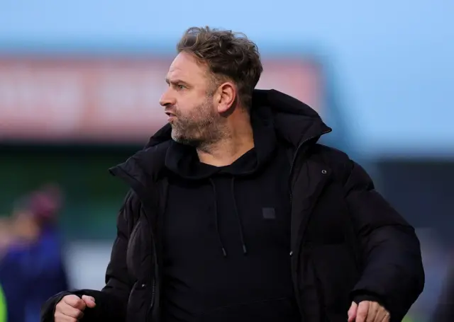 Lee Feeney watching his Bangor team in action at Mourneview Park
