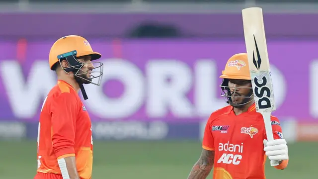 Pathum Nissanka raises his bat alongside a team-mate