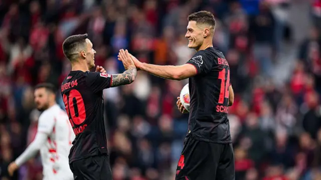 Patrik Schick and Alejandro Grimaldo celebrating a goal with a high five