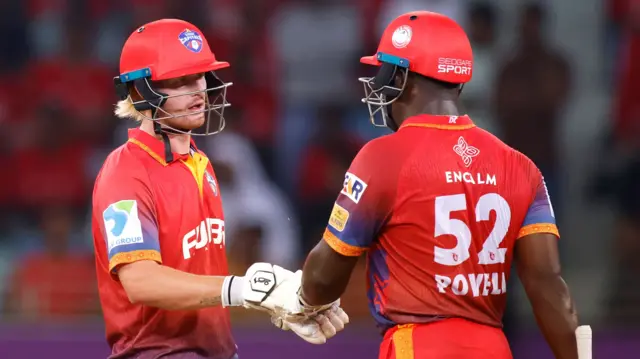 Jordan Cox and Rovman Powell punch gloves