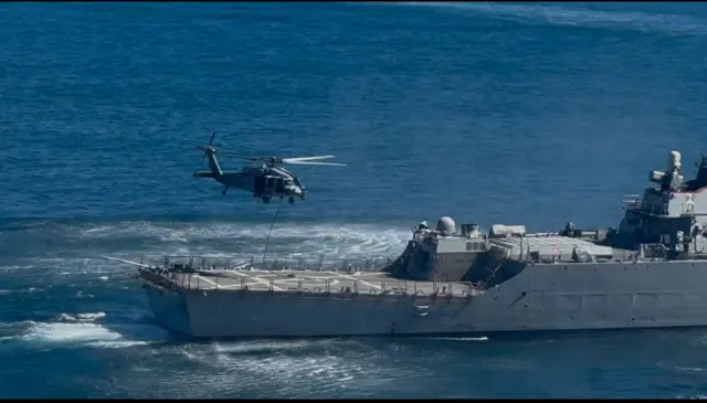 Naval commandos fast-roping onto the deck of a ship in October