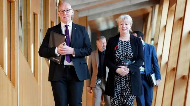 John Swinney and Shona Robison walking tot he Holyrood chamber