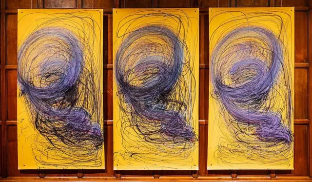 Three large yellow paintings by Nnena Kaluin a row with identical blue swirly patterns