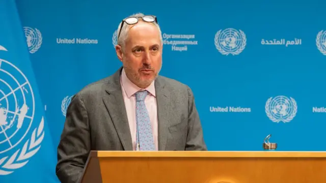 Stephane Dujarric speaking at a podium