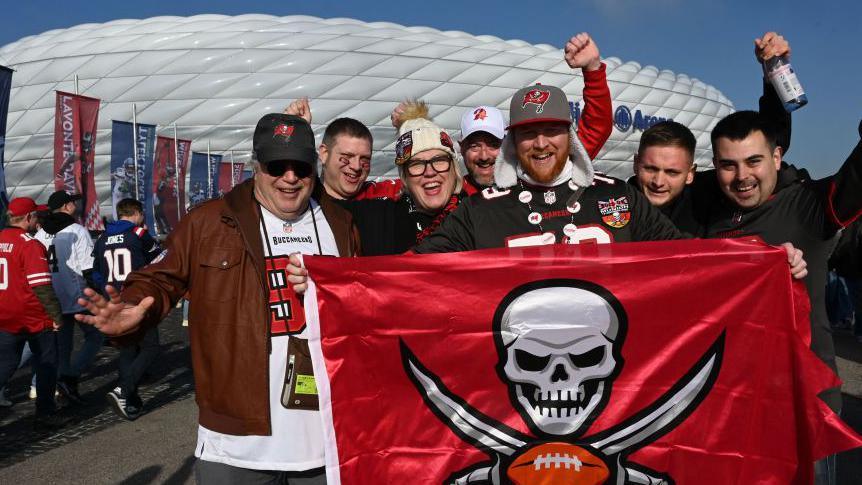 Tampa Bay Buccaneers fans pose for a photo as they arrive for the NFL game between the Seattle Seahawks and the Buccaneers at the Allianz Arena in Munich in 2022