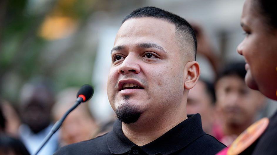 Image of Kilmar Abrego Garcia speaking into a microphone at a rally on August 25, 2025 in Baltimore, Maryland.