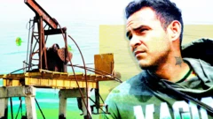 A designed image of a old rusty oil pump on the left and a young man with dark hair on the right. He is looking wistfully into the distance. He is wearing a grey hoodie with magic written on it in white and green letters.