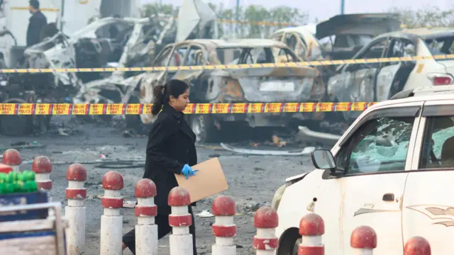 A member of the forensic team works at the site of an explosion near the historic Red Fort in the old quarters of Delhi, India, November 11, 2025. REUTERS/Adnan Abidi