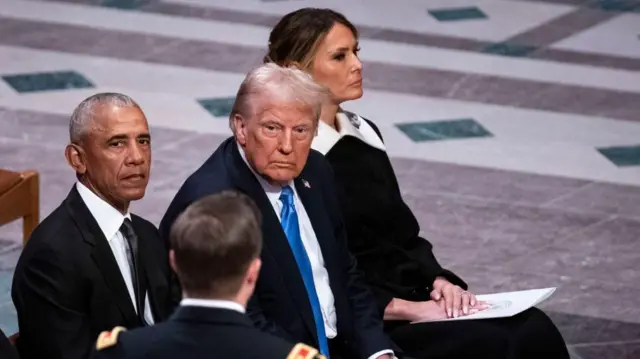 Melania Trump sits next to her husband Donald Trump and former President Barack Obama