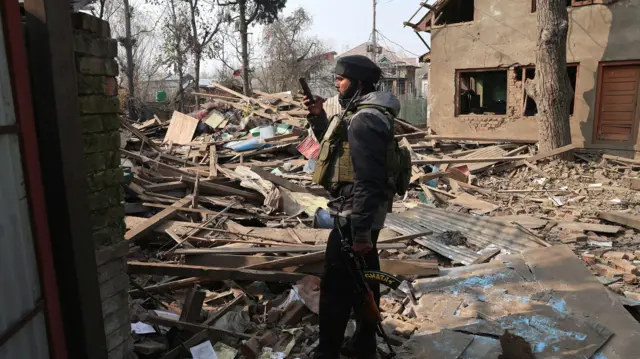 Mandatory Credit: Photo by FAROOQ KHAN/EPA/Shutterstock (15793125f)
An Indian soldier takes a photograph of the demolished house of Umar Nabi, the primary suspect in the Delhi car blast, in his hometown of Koil, Pulwama district, south of Srinagar, Indian-administered Kashmir, 14 November 2025. Umar Nabi is accused of having driven the explosive-laden car that detonated near the Red Fort Metro station on 10 November.
House of Delhi blast key suspect demolished in Kashmir, Pulwama, India - 14 Nov 2025
