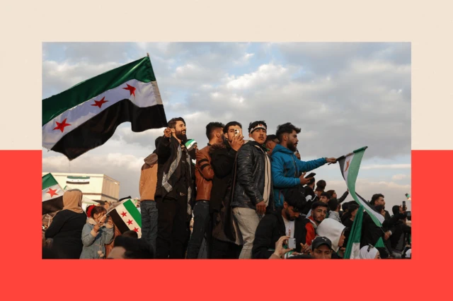 People wave flags during celebrations for the ousting of president Bashar al-Assad