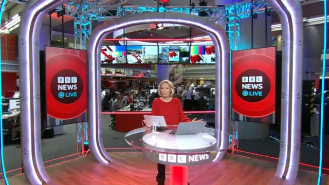 Kasia Madera presenting a news programme in the BBC studio