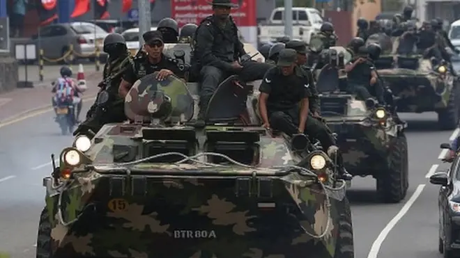 Army soldiers travel in armored vehicles along a road in the Battaramulla area near Colombo On July 14, 2022. The government has declared an emergency, and a curfew is in the Colombo district from 12 noon today (14) to until 5 am tomorrow (15)
