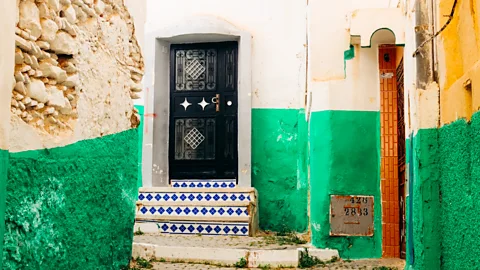 A door outside a building with green and white painted sides (Credit: Alicia Erickson)