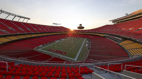 A crowd wearing rain ponchos in the stands at a football stadium (Credit: Getty Images)