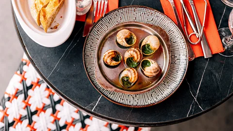 Snails on a plate at a bistro (Credit: Getty Images)