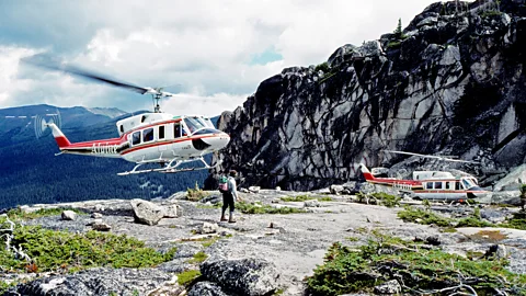 Alamy Two helicopters landing in Canada's Purcell Mountains dropping off a hiker (Credit: Alamy)