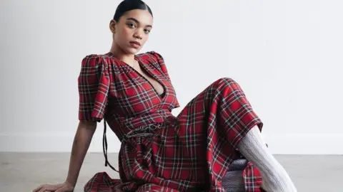 Model wearing a tartan dress made by designer Annabel Stewart.